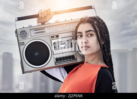 Im about that boombox life. Cropped portrait of an attractive young female dancer standing with her boombox on a rooftop against a stormy backdrop. Stock Photo
