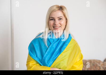 woman and flag of ukraine. Showing support and solidarity for Ukraine. Stock Photo