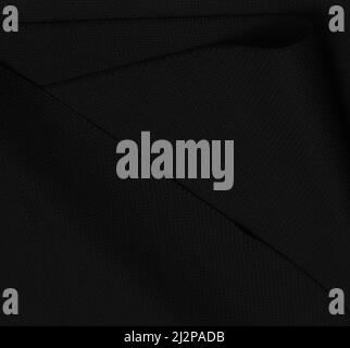 Black fabric texture background. Texture fabric for embroidery. Black blank canvas with pleats as a background Stock Photo