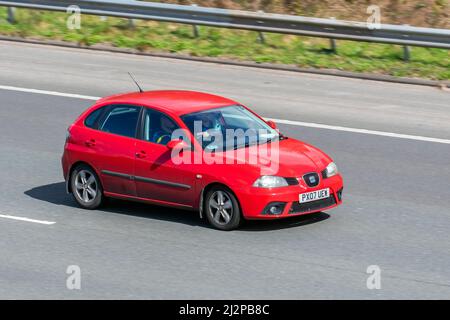 2007 red Seat Ibiza S 1198cc petrol 4dr; driving on the M61 motorway, Manchester, UK Stock Photo