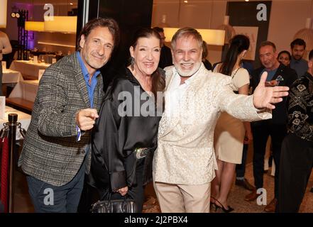 Hamburg, Germany. 03rd Apr, 2022. Falk Willy Wild (l-r), Katy Karrenbauer, both actors, and Froonck, The Weddingplaner, come to the Alstertal Shopping Center for the benefit event in favor of actress M. Ahrens' Lebensherbst association. Half of the proceeds will go to the association, which cares for lonely and needy seniors nationwide, and half to humanitarian aid for Ukraine. Credit: Georg Wendt/dpa/Alamy Live News Stock Photo