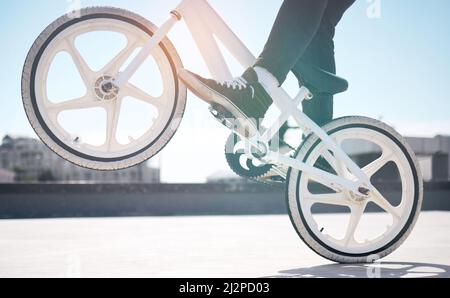 Trickin. Cropped shot of an unrecognizable man riding his BMX outside. Stock Photo