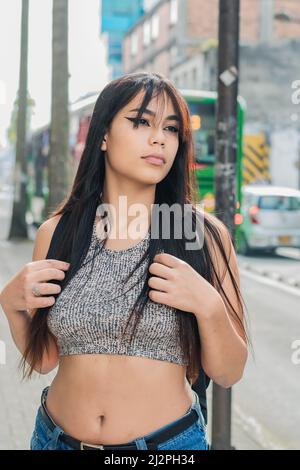 A beautiful black long hair latina scuba diver diving underwater with