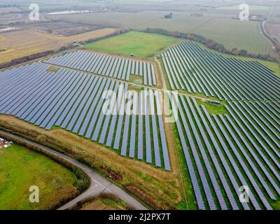 Aerial drone shot. Solar panels farm in a field near Sittingbourne in Kent, England. Stock Photo