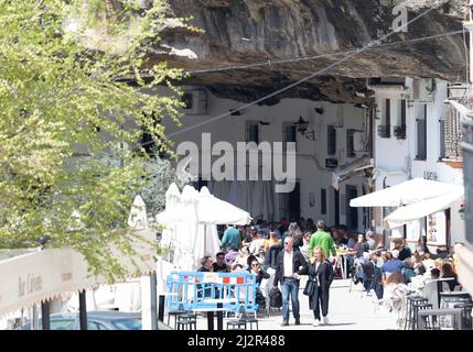 Tourists visting the bars and restaurants that are dug into the mountain caves in Setenil de las Bodegas Stock Photo