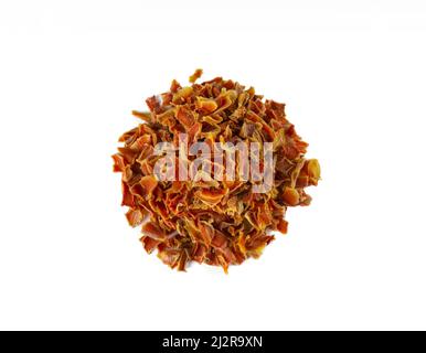 dried carrot pieces heap isolated on white background. Spices and food ingredients. Stock Photo
