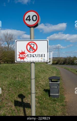 Roadside 40mph speed limit and no mobile phone use signs on Oakham bypass, Rutland, England, UK Stock Photo