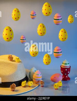 Colorful easter eggs with chicks and straw hat Stock Photo
