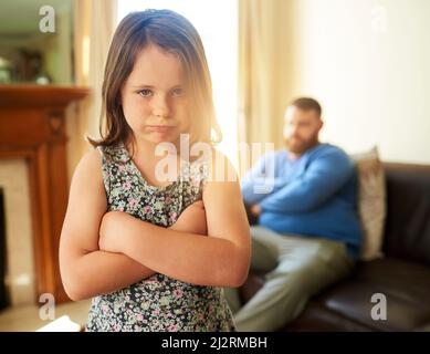Its all fun and games until Dad says no. Shot of an unhappy little girl sulking after a disagreement with her father. Stock Photo