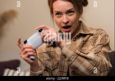 Macro shot. Emotional girl plays a video game. Passion, virtual reality, cyberspace, cybersport, new modern technologies, communication, emotional unl Stock Photo