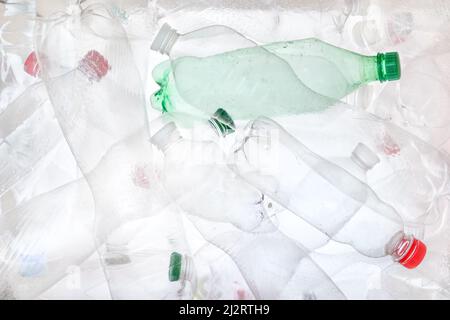 Empty plastic bottles background. Water PET bottle recycling plastic material recyclable waste sorting. Recyclable trash recycle garbage concept. Many Stock Photo