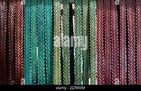 Coloured Leather Belt Background hanging vertically Stock Photo