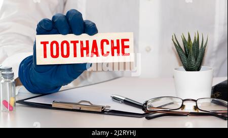 Toothache word written on wood block, concept Stock Photo