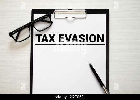 Text sign showing Tax Evasion. Conceptual photo the failure to pay or the deliberate underpayment of taxes Note paper taped to black computer screen n Stock Photo