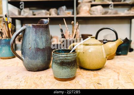 Handmade ceramic jugs and kettles. Popular art. Stock Photo