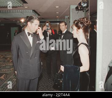 Prince Charles talked to Robyn Gibson, whilst her actor husband Mel Gibson looks on, at the film premiere of A Man Without a Face in London.  Picture taken 16th November 1993 Stock Photo
