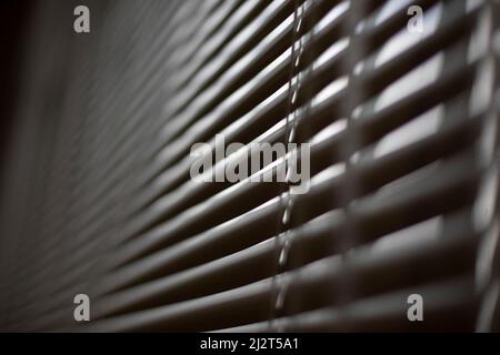 Blinds on window. White blinds cover window from sun. Interior details. Shooting diagonally. Stock Photo