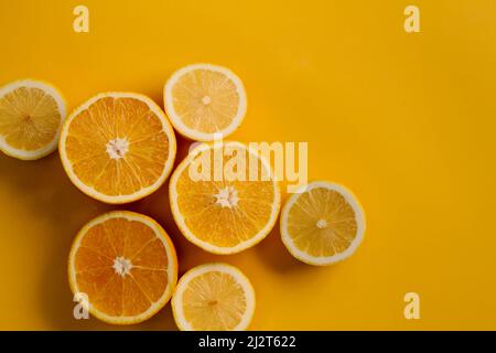 Flat lay top view, slices of fresh orange on yellow background Stock Photo