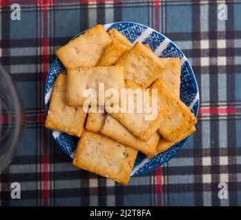 Thin crackers with sesame seeds on plate Stock Photo