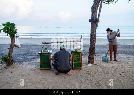 A couple selling bubur ijo or green bean soup at Kuta Beach, Bali in the early morning. Stock Photo
