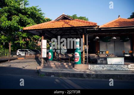 Jalan Kartika Plaza in Kuta, Bali with it's famous KaBar Grill Bintang Beer bottle on the left. Stock Photo