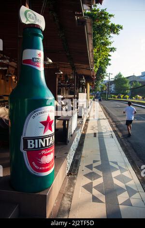 Jalan Kartika Plaza in Kuta, Bali with it's famous KaBar Grill Bintang Beer bottle on the left. Stock Photo