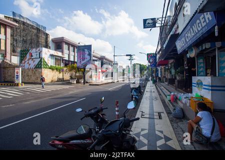 Jalan Kartika Plaza in Kuta, Bali, with Discovery Mall on the left and shops on the left. The street is very empty due to the pandemic. Stock Photo