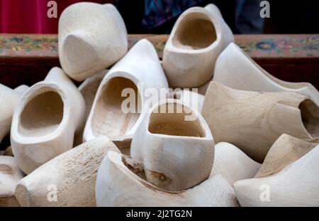 A pile of wooden shoes are on display and for sale at a tulip festival in Holland Michigan USA Stock Photo