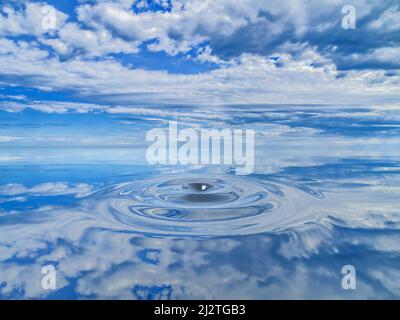 Overcast sky reflected on undulations in cold blue water Stock Photo