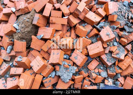 brick fight - halves of new bricks are piled up mixed with other construction debris, selective focus Stock Photo