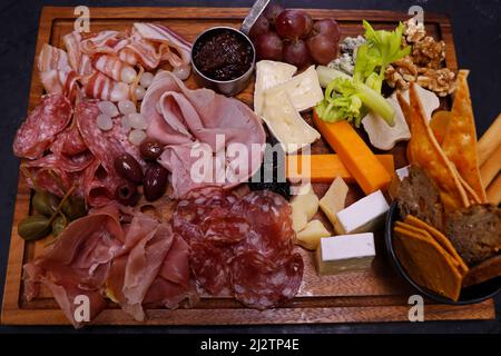 assorted cheese and cold meat platter or board with condiments Stock Photo