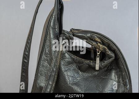 An old black woman's bag. Close-up of a woman's leather clothing accessory Stock Photo
