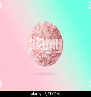 Creative Easter concept of light pink long fiber soft fur egg. Pastel background. Fuzzy shaggy blanket. Fluffy fake textile.  Fashion style winner egg Stock Photo