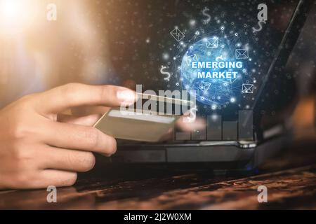 Emerging Markets Internet Technology Business Concepts and Networks Young businessman hand holding a credit card works on a futuristic virtual screen Stock Photo