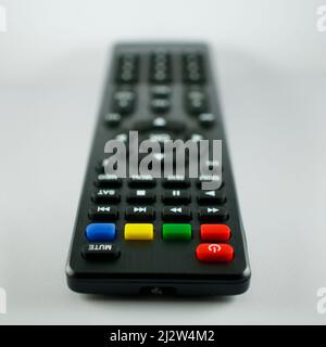 TV remote control. Infrared light-operated television, music system, dvd reader, satellite receiver remote control. Isolated on white background. Focu Stock Photo