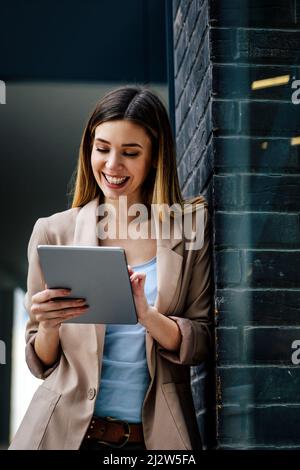 Portrait of successful woman using digital tablet in urban background. Business people concept Stock Photo