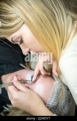 Eyelash extension procedure in beauty salon. Lashes close up. Concept spa lash.  Stock Photo