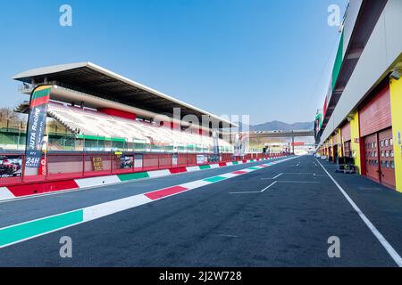 Racing circuit starting straight racetrack large view from pit lane, box and grandstand no people. Mugello, Italy, march 26 2022. 24 Hours series Stock Photo