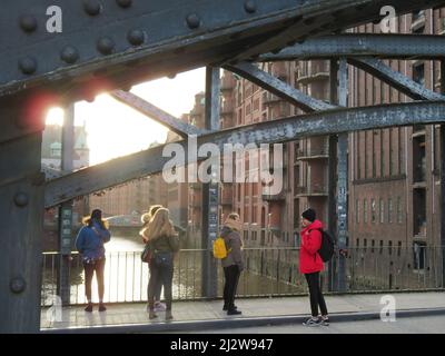 Germany - Tourists admire the old warehouses at the Wandrahmfleet at the Hamburger Speicherstadt Germany Stock Photo