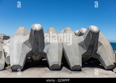 Selective focus on two large concrete dolos.  Dolos is used as break water in harbours and to protect against coastal erosion Stock Photo