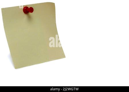 Close up of yellow postit note with red pin needle on white background as concept for office reminders notes and todos Stock Photo