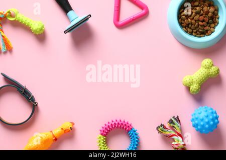 Flat lay composition with pet accessories, toys, feed on pink table. Pet care, training, grooming concept. Pet shop banner mockup. Stock Photo