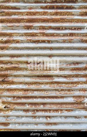 Old weathered and rusty corrugated metal sheet Stock Photo