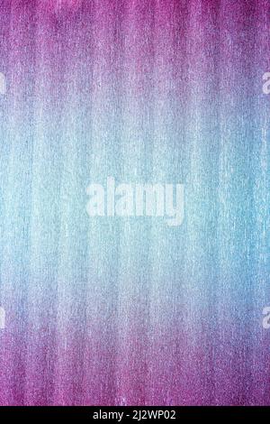 Rough texture of folded shiny metallic crepe paper or foil colored in pink to blue intense neon gradient. Abstract bright background with large copy s Stock Photo