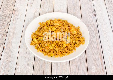 Fried Rice with Prawns · In a medium skillet over medium heat, heat the oil. Add the garlic and stir for a minute. · Add the rice and peas and season Stock Photo