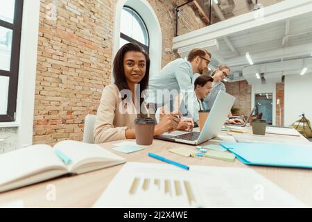 Businessmen, women in suit and glases on workplace Stock Photo