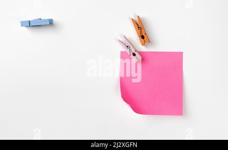 Clothespins and sticker on white Stock Photo