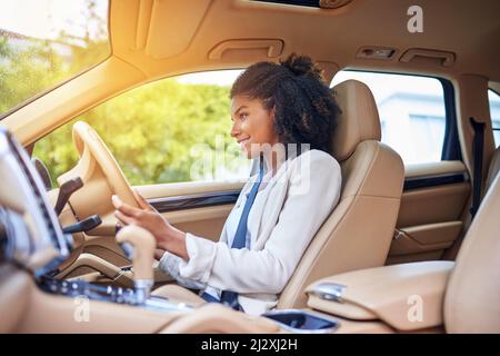 She enjoys her morning commute. Cropped shot of an attractive young businesswoman driving to work on her morning commute. Stock Photo