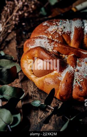 closeup of a traditional Spanish mona de pascua, a cake eaten on Easter Monday, ornamented with hard-boiled eggs and topped with sugar and sprinkles o Stock Photo