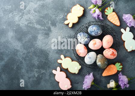 Easter eggs. Dyed Easter eggs with marble stone effect ref and blue color in rustic style on dark stone background. Easter background. Top view. Stock Photo